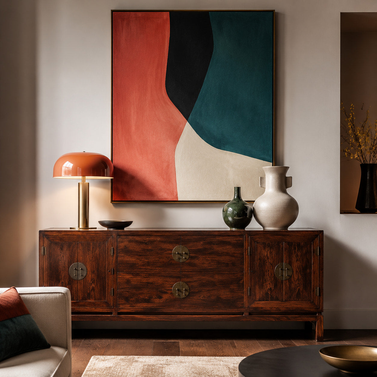 Vintage sideboard styled with modern artwork and decorative lighting