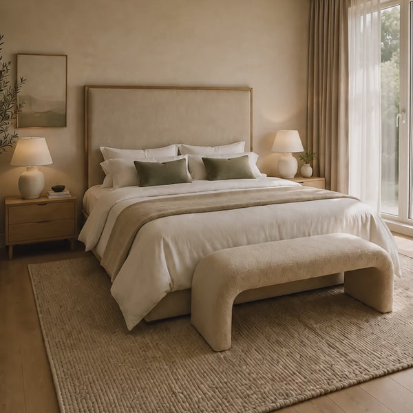 Primary bedroom sanctuary with calming colors, layered bedding, blackout curtains, and warm lighting
